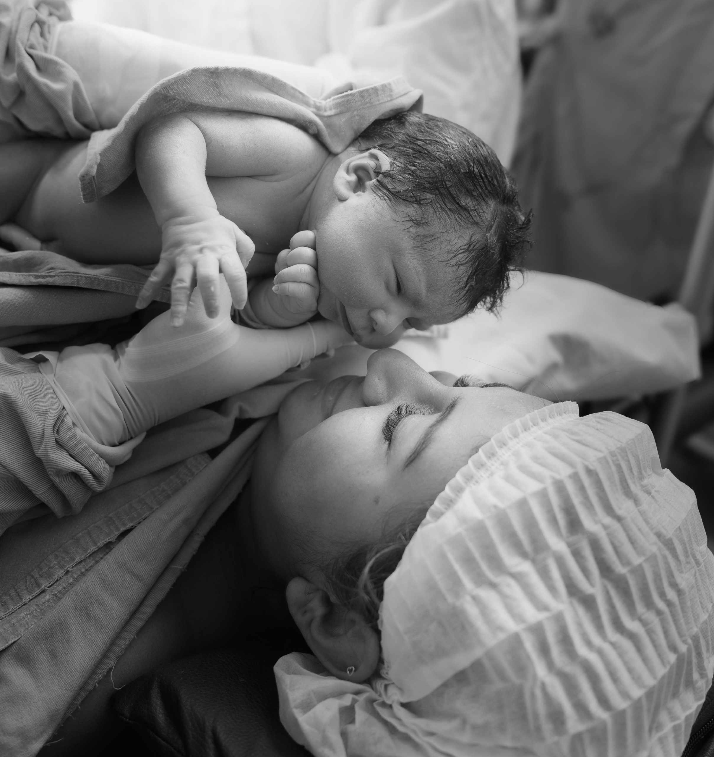 Home A touching moment between a mother and her newborn baby shortly after birth in a hospital.
